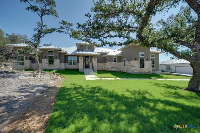 view of front of house featuring a garage and a front lawn