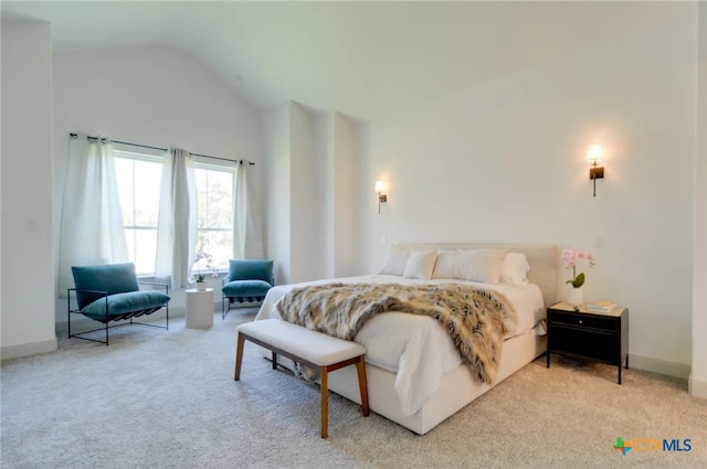 bedroom featuring carpet floors and vaulted ceiling