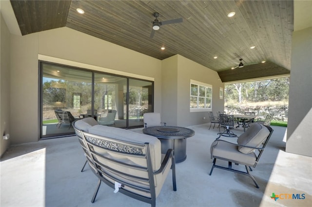 view of patio / terrace with an outdoor fire pit and ceiling fan