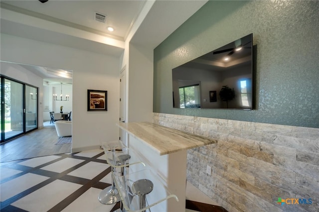 hall featuring ornamental molding and a raised ceiling