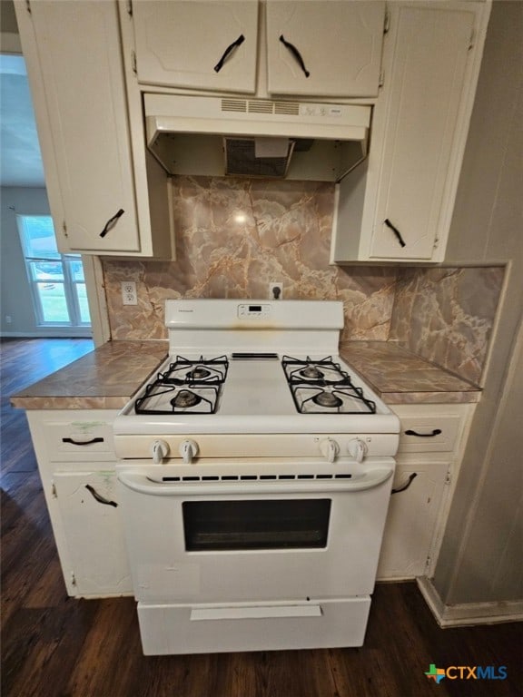 620 Bishop Dr, Killeen, TX 76541 - kitchen with decorative backsplash, under cabinet range hood, white gas range, white cabinets, and dark wood-style floors