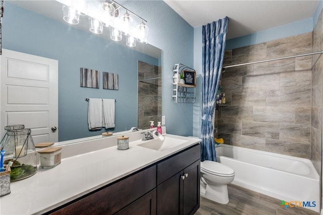 bathroom with shower / bath combo, toilet, vanity, and wood finished floors