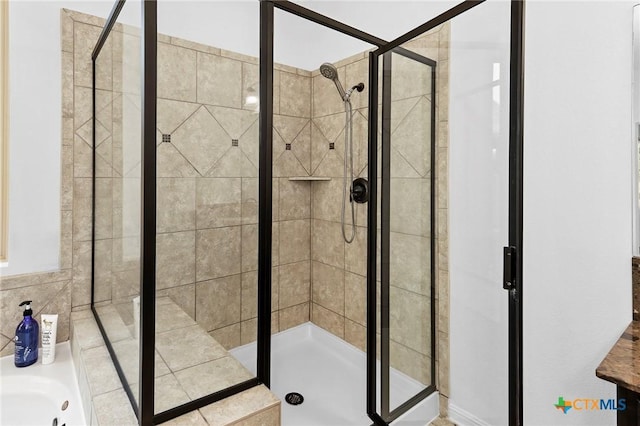 bathroom featuring a bath and a stall shower