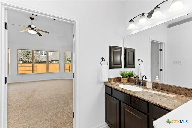 bathroom with baseboards, vanity, and ceiling fan