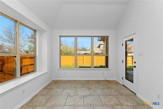 unfurnished sunroom featuring vaulted ceiling