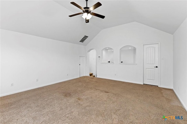 interior space with a ceiling fan, baseboards, arched walkways, carpet, and lofted ceiling