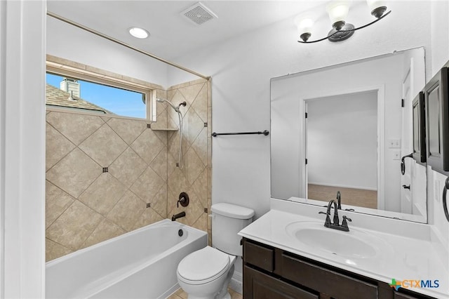 full bathroom with vanity, toilet, washtub / shower combination, and visible vents