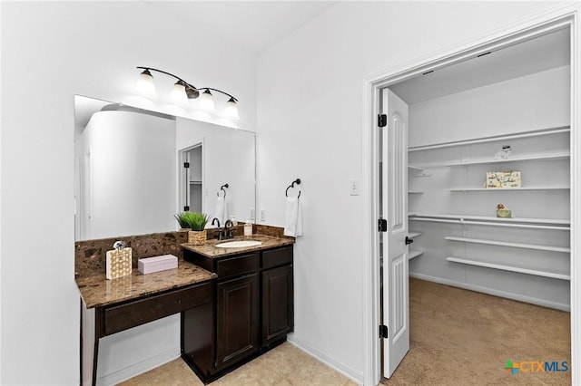 bathroom with baseboards and vanity