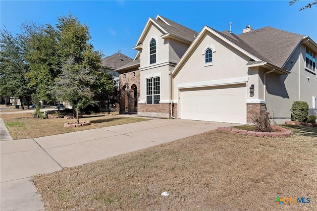 traditional home with stucco siding, driveway, a front lawn, and a garage