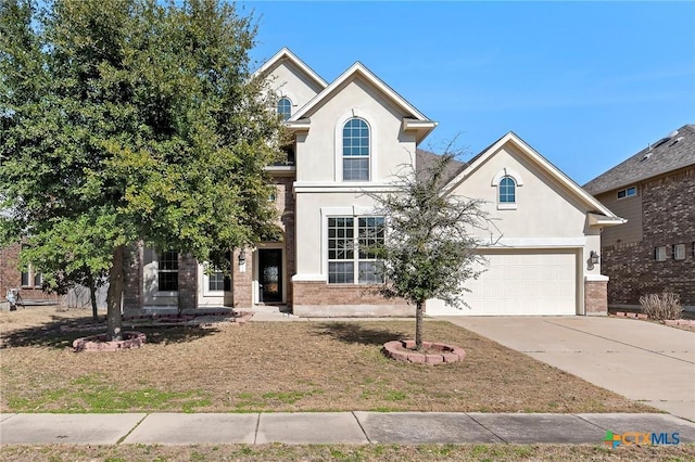 traditional-style house with stucco siding, brick siding, and driveway