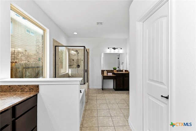 bathroom with visible vents, a stall shower, tile patterned flooring, a bathtub, and vanity