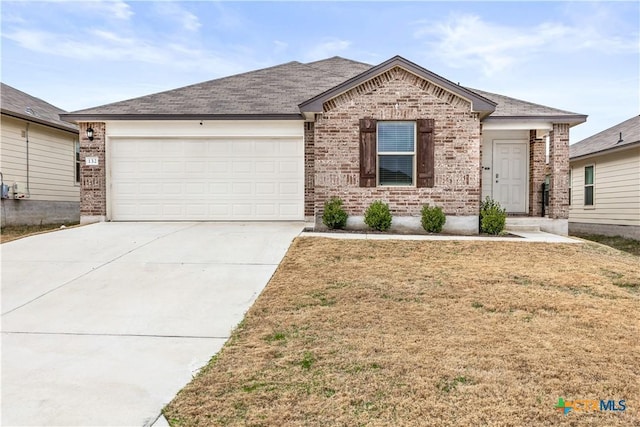 view of front of home with a front yard and a garage