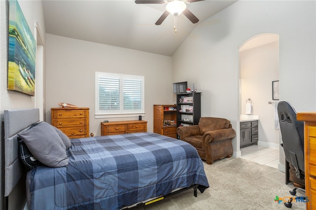 bedroom with ensuite bathroom, ceiling fan, lofted ceiling, and light carpet