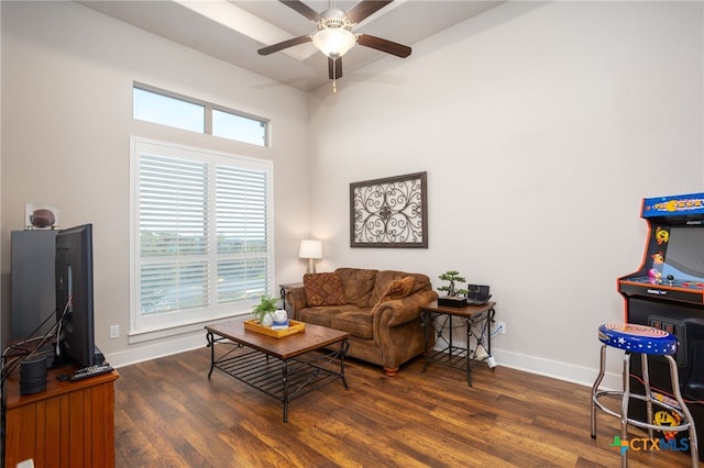 living room with ceiling fan and dark wood-type flooring