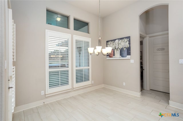 empty room featuring a chandelier