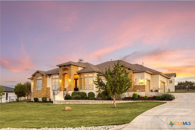 prairie-style house with a lawn and a garage