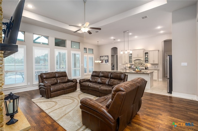 living room with ceiling fan, dark hardwood / wood-style flooring, and sink