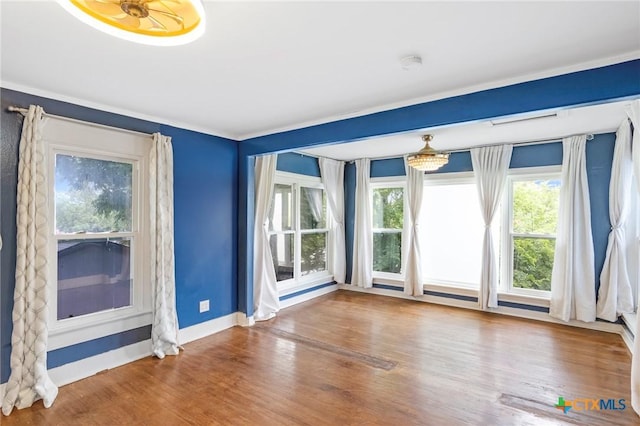 1200 4th St, Palacios, TX 77465 - spare room featuring wood finished floors, a smoke detector, baseboards, and crown molding