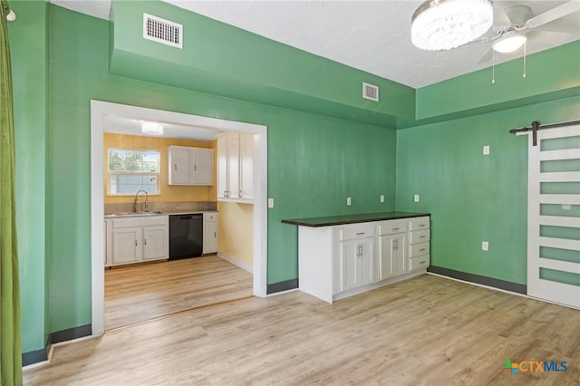 1200 4th St, Palacios, TX 77465 - kitchen with dishwasher, a ceiling fan, white cabinets, and light wood-style floors