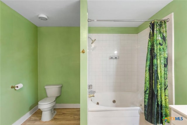 1200 4th St, Palacios, TX 77465 - bathroom with a combined bath / shower with jetted tub, toilet, wood finished floors, and baseboards