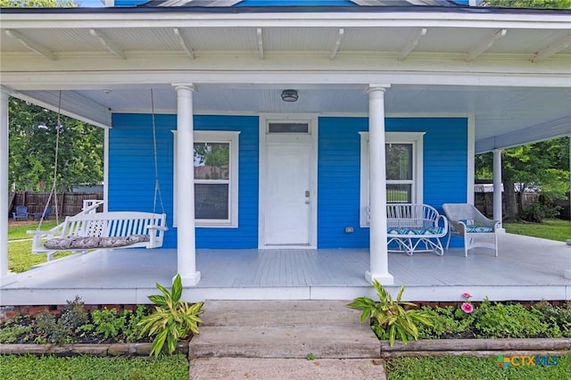 1200 4th St, Palacios, TX 77465 - view of exterior entry featuring covered porch and fence