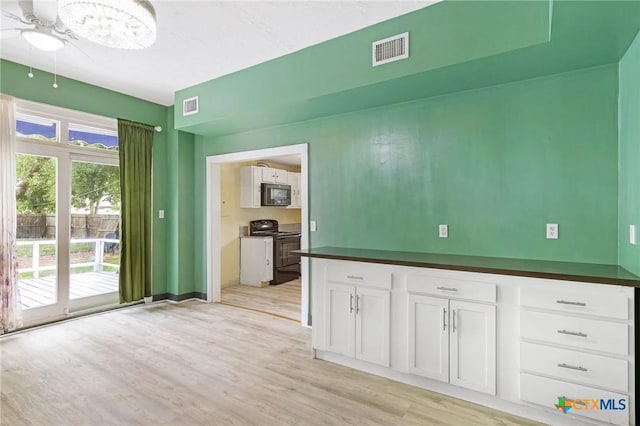 1200 4th St, Palacios, TX 77465 - empty room with light wood-style flooring, ceiling fan, and baseboards