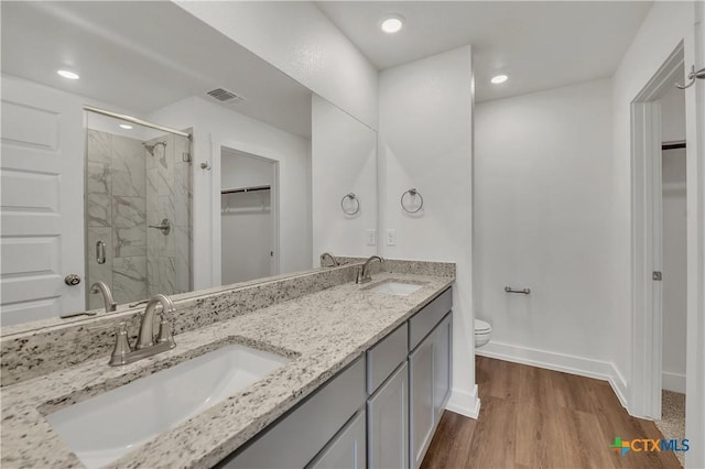 2310 Healy Dr, Temple, TX 76502 - bathroom featuring a stall shower, visible vents, a sink, and wood finished floors