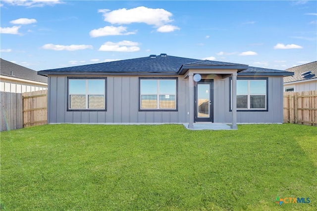 2310 Healy Dr, Temple, TX 76502 - rear view of property featuring a yard, board and batten siding, a shingled roof, and a fenced backyard