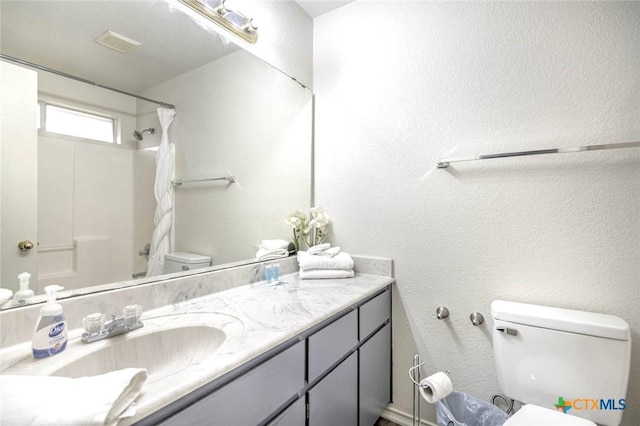 full bathroom with toilet, vanity, and shower / bath combination with curtain