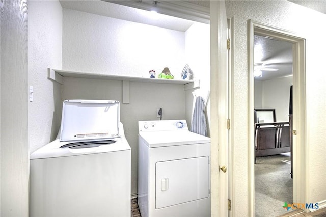 clothes washing area with separate washer and dryer, ceiling fan, and dark colored carpet