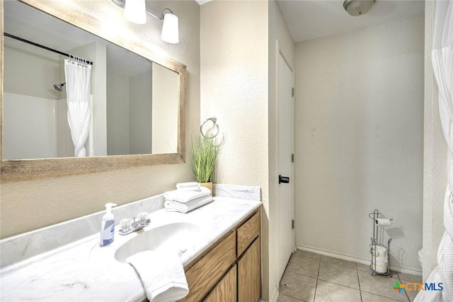 bathroom with vanity, tile patterned floors, and walk in shower