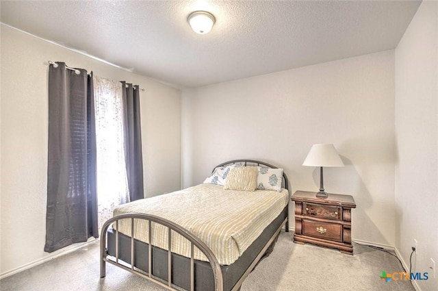 carpeted bedroom featuring a textured ceiling and multiple windows