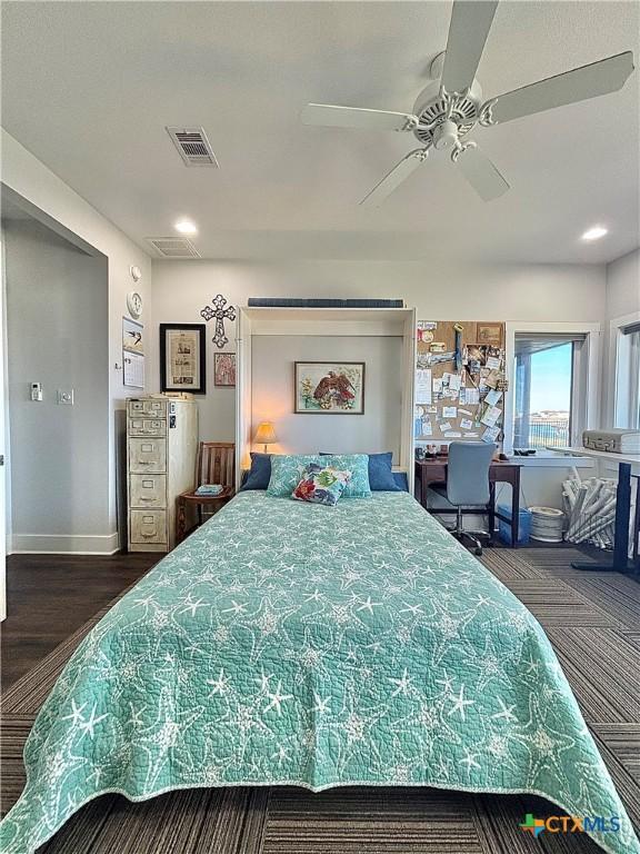 bedroom with ceiling fan and dark hardwood / wood-style flooring