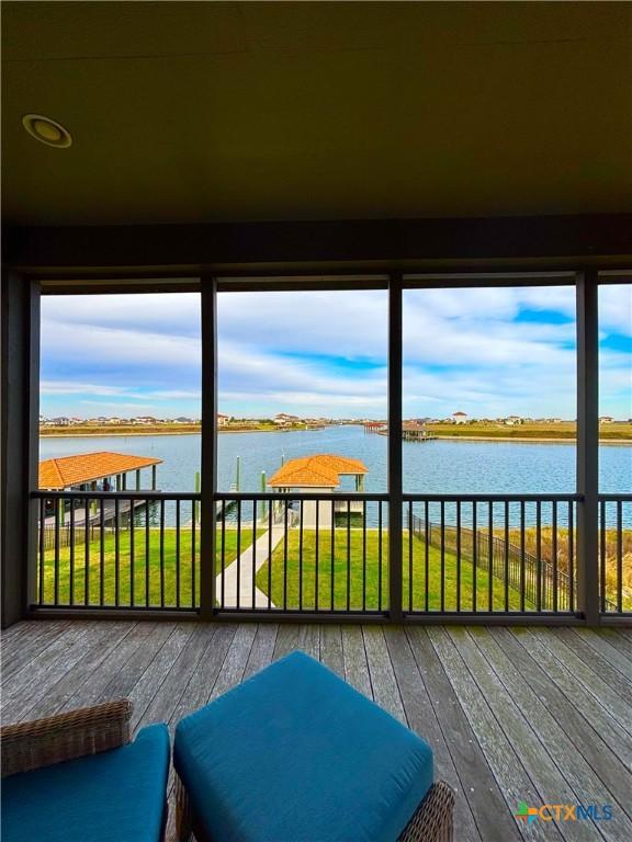 unfurnished sunroom with a water view and plenty of natural light