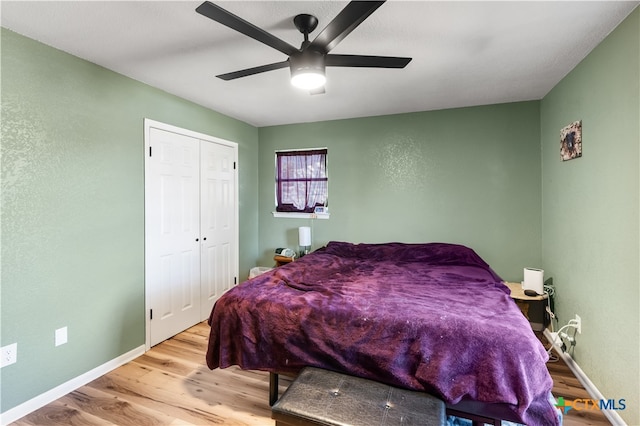 bedroom with light wood-type flooring, a closet, and ceiling fan