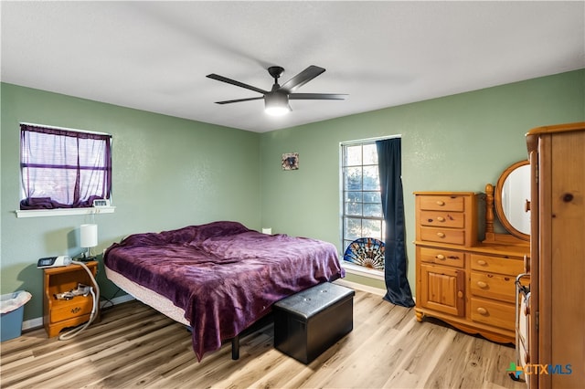 bedroom with light hardwood / wood-style flooring and ceiling fan