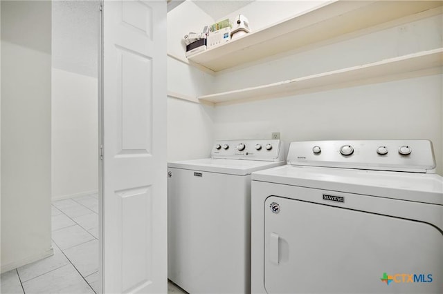 2991 Lakeview E Dr, Ingleside, TX 78362 - washroom featuring washing machine and dryer, baseboards, and light marble finish floors