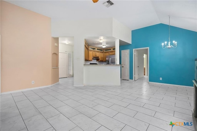 2991 Lakeview E Dr, Ingleside, TX 78362 - unfurnished living room with lofted ceiling, a chandelier, baseboards, and light tile patterned floors