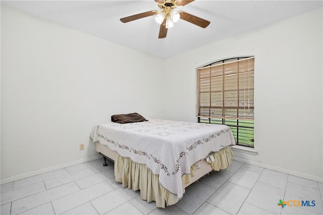 2991 Lakeview E Dr, Ingleside, TX 78362 - bedroom with baseboards, a ceiling fan, and light marble finish flooring