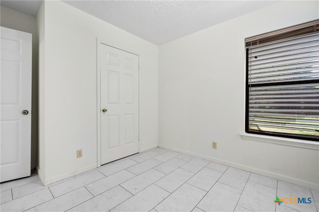 2991 Lakeview E Dr, Ingleside, TX 78362 - unfurnished bedroom featuring baseboards and a textured ceiling