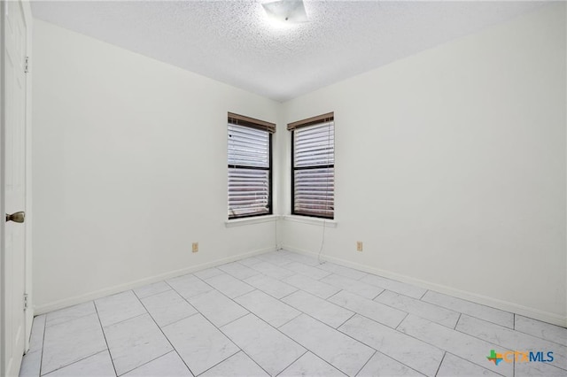2991 Lakeview E Dr, Ingleside, TX 78362 - spare room featuring a textured ceiling and baseboards