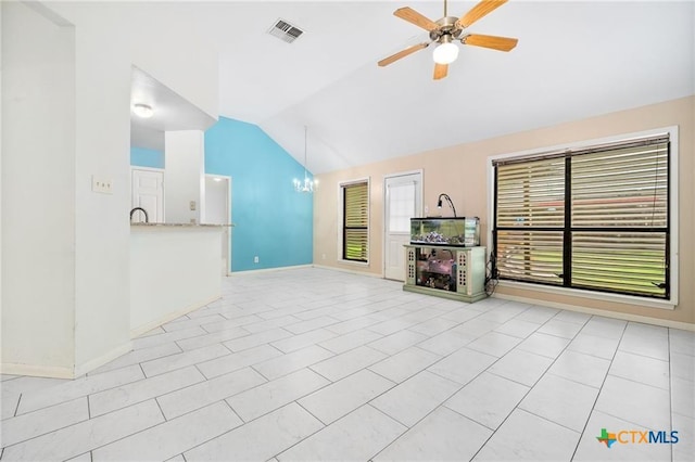 2991 Lakeview E Dr, Ingleside, TX 78362 - unfurnished living room with lofted ceiling, a ceiling fan, baseboards, and a chandelier