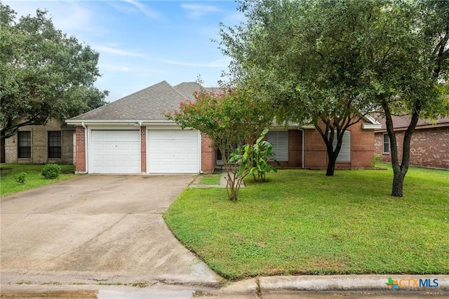 2991 Lakeview E Dr, Ingleside, TX 78362 - view of front facade with an attached garage, concrete driveway, a front lawn, brick siding, and a shingled roof