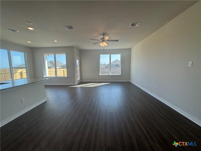 spare room featuring baseboards and dark colored carpet