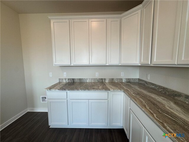 kitchen featuring stainless steel microwave, range with electric cooktop, visible vents, white cabinetry, and a sink