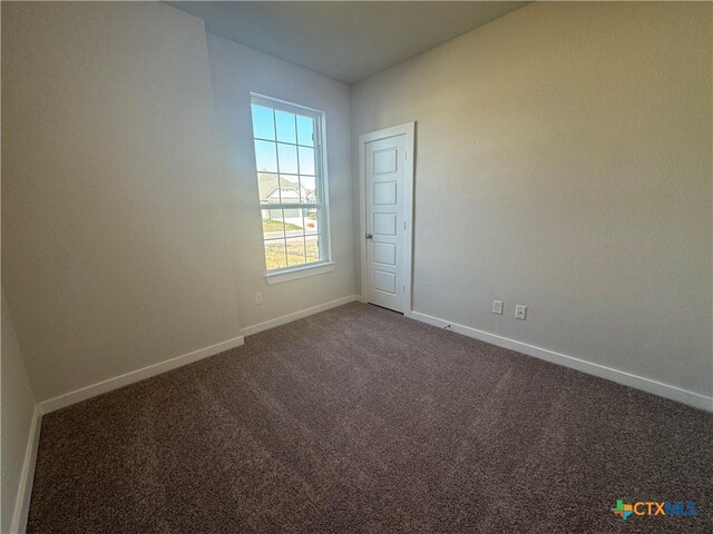 interior space featuring visible vents, baseboards, dark wood-type flooring, and ceiling fan