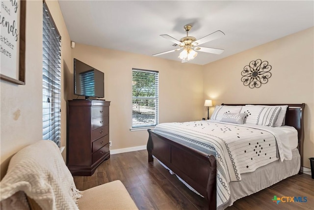 bedroom with dark wood-style floors, baseboards, and a ceiling fan