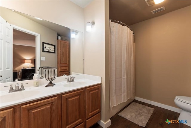 full bath with visible vents, a sink, ensuite bath, and double vanity