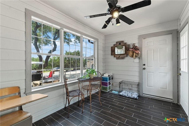 sunroom / solarium with a ceiling fan and a healthy amount of sunlight