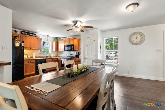 dining room with a ceiling fan, baseboards, and dark wood-style flooring